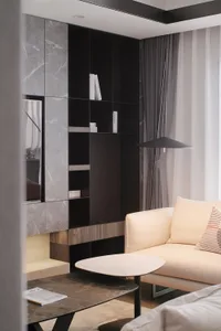 A modern living room with marble floor and black accents