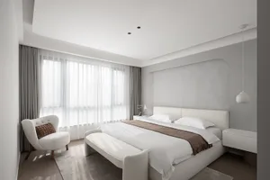 A modern bedroom with a bed dressed in fabric and white curtains.
