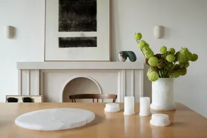 A minimalist room featuring stone elements and greenery.
