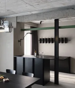 Industrial-style bar with dark metal counter and green trim.
