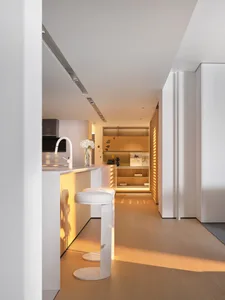 Contemporary kitchen with white cabinets and flat panel design.