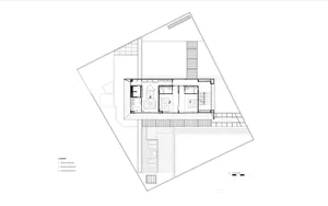 Floor plan of a modern residential building with a central staircase, standard bedrooms, and an open living space.