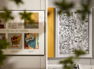 Two framed artworks hanging on a wall; one featuring various abstract paintings, the other a dense, intricate drawing of many