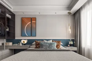 A modern bedroom featuring soft textured fabric bedding against a sleek metal and glass headboard, with a geometric pattern o