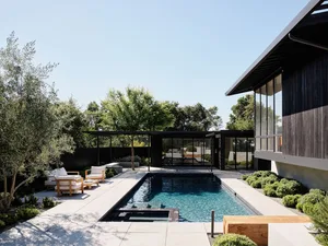 Outdoor patio featuring a modern house with a concrete and wooden design.