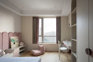Minimalist bedroom featuring a white bed with a pink upholstered headboard, a pink bean bag chair, a wooden floor, and large 
