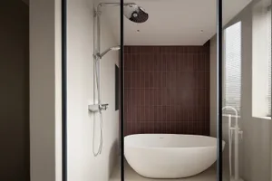 A modern bathroom featuring a white freestanding bathtub, a dark brown tiled wall, and a walk-in shower with a glass enclosur