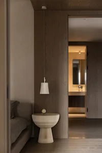 Modern minimalist bedroom with wooden features and lighting