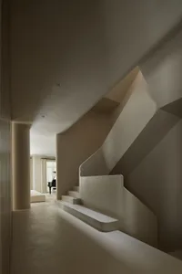 A minimalist staircase constructed from white concrete.