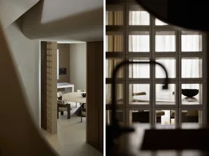 Modern residential kitchen featuring a round marble table and contemporary seating arrangement.