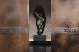 A detailed metal sculpture of a horse's head mounted on a wall.