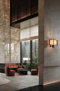 A modern living room with a concrete fireplace, featuring comfortable seating and a sleek, minimalist design.