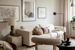 Modern living room featuring neutral tones with minimalist decor and comfortable seating.