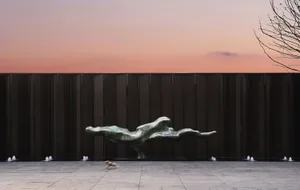 A modern abstract metal sculpture displayed in an outdoor public space.
