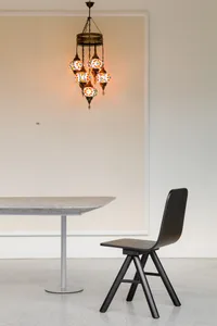 Minimalist black and white table and chair with mosaic light fixture