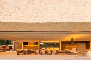 View of a modern residential interior featuring concrete and wooden elements.