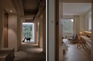 A modern residential interior with a minimalist design featuring concrete finishes and natural light.