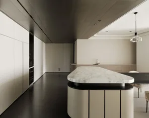 Modern, minimalist kitchen featuring marble countertops and natural wood cabinetry.