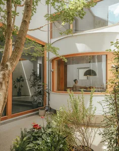 Modern interior with wooden accents, glass doors, and minimalist design in a cement structure.