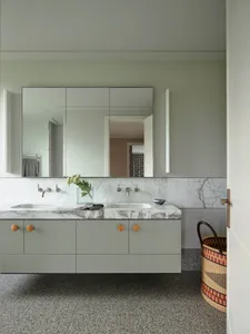 Modern bathroom with marble counter top and grey cabinets