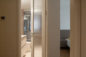 Modern bathroom featuring a white glass door, clean lines, and minimalist design elements.