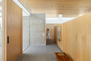 Modern entrance featuring wood and concrete materials.