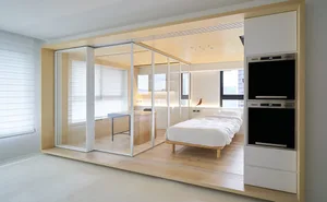 A modern minimalist living room featuring wood elements and a clean, open design.