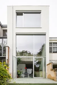 Modern house with large glass windows and door.