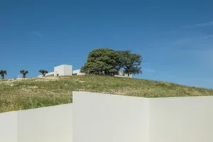 Modern building with concrete structure surrounded by greenery.