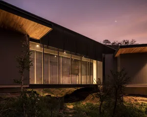 Modern house exterior with metal clad ends, glass ceilings, and wooden roofing