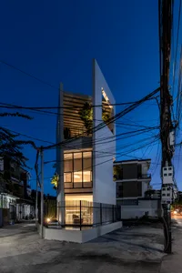 Modern interior design featuring glass elevations at night with illuminated windows.