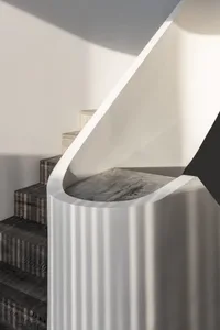 Modern staircase design featuring concrete steps and railings.