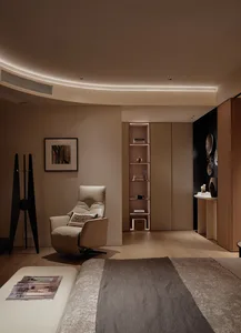 A minimalist bedroom featuring a wooden floor and furniture.