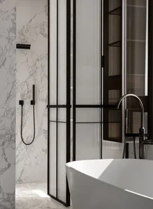 Modern bathroom featuring a freestanding bathtub and marble walls and floor.