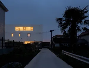 A minimalist, modern residential exterior with concrete finish.