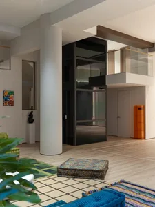Modern living room with wooden flooring, contemporary furniture, and open-concept design.