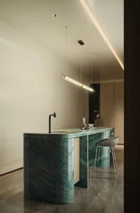 Modern kitchen with green marble countertops and black faucet