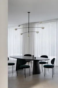 A modern dining room featuring dark wooden furniture and a minimalist design.