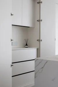 A minimalist interior space with white marble finishes.