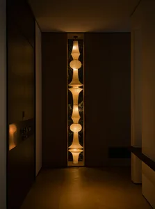 Modern marble corridor illuminated by decorative lamps