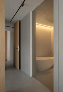 An elegant modern bathroom featuring concrete walls and minimalist design.