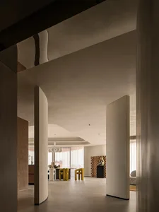 Modern living room with neutral-toned furniture and clean lines.
