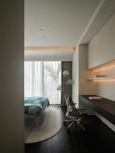 Modern minimalist bedroom with neutral tones, featuring a bed covered in blue and green checkered bedding and a sleek, ergono