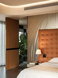 Modern bedroom with textured wall covering, minimalist design, and sleek, open concept layout.