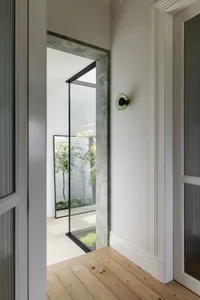 A minimalist interior design with marble accents and a brightly lit space.