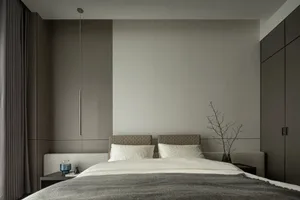 Modern, minimalist bedroom featuring a textured headboard and bedding.