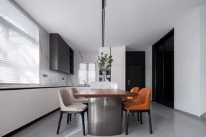 A modern kitchen and dining room featuring a combination of metal and wood furniture.
