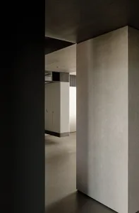Modern minimalist living room with concrete and marble accents.