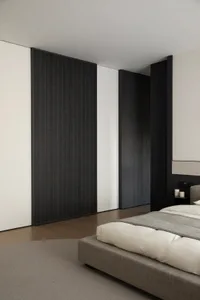 Modern minimalist bedroom with wood-textured walls, neutral color palette, and minimal furniture.
