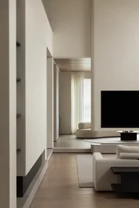 A modern minimalist living room featuring concrete walls and flooring with a sleek, white sofa and coffee table.